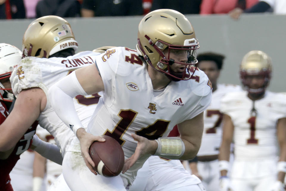 Boston College quarterback Emmett Morehead (14) looks to hand off the ball during the first half of an NCAA college football game against North Carolina State, Saturday, Nov. 12, 2022, in Raleigh, N.C. (AP Photo/Chris Seward)