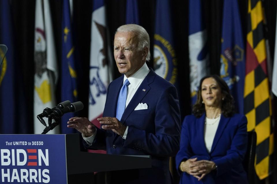 Presumptive Democratic presidential nominee former Vice President Joe Biden (L) speaks as his running mate Sen. Kamala Harris (D-CA) looks on during an event in Wilmington, Delaware.