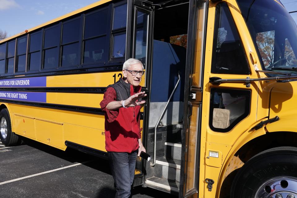 Wisconsin Democratic Gov. Tony Evers gets on a bus after speaking at a campaign stop Thursday, Oct. 27, 2022, in Milwaukee. (AP Photo/Morry Gash)