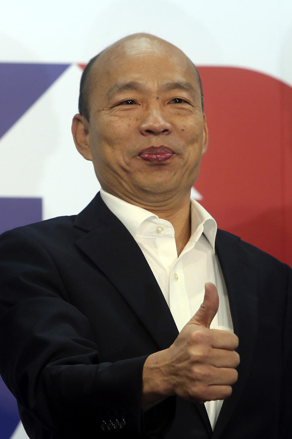 Han Kuo-yu of the Nationalist Party shows a thumbs-up during a media event announcing his campaign logo in Taipei, Taiwan, Thursday, Nov. 14, 2019. The China-friendly opposition candidate in Taiwan’s upcoming presidential election is urging Hong Kong to adopt universal suffrage as the best way of stemming months of anti-government protests. (AP Photo/Chiang Ying-ying)