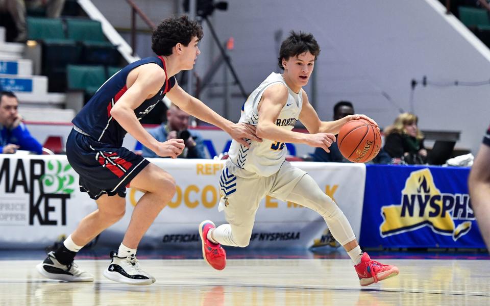 Irondequoit's Quinn VanKerkhove, right, is defended by South Side's James Murphy during a NYSPHSAA Class A Boys Basketball Championship semifinal in Glens Falls, N.Y., Friday, March 17, 2023. Irondequoit advanced to the Class A final with a 50-29 win over South Side-VIII.