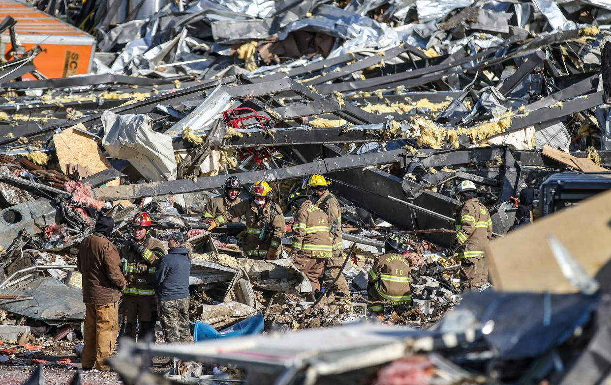 Rescue teams search for people among the remains of the candle factory in Mayfield, Ky. After a deadly tornado ripped through the small community.  Dec. 11, 2021