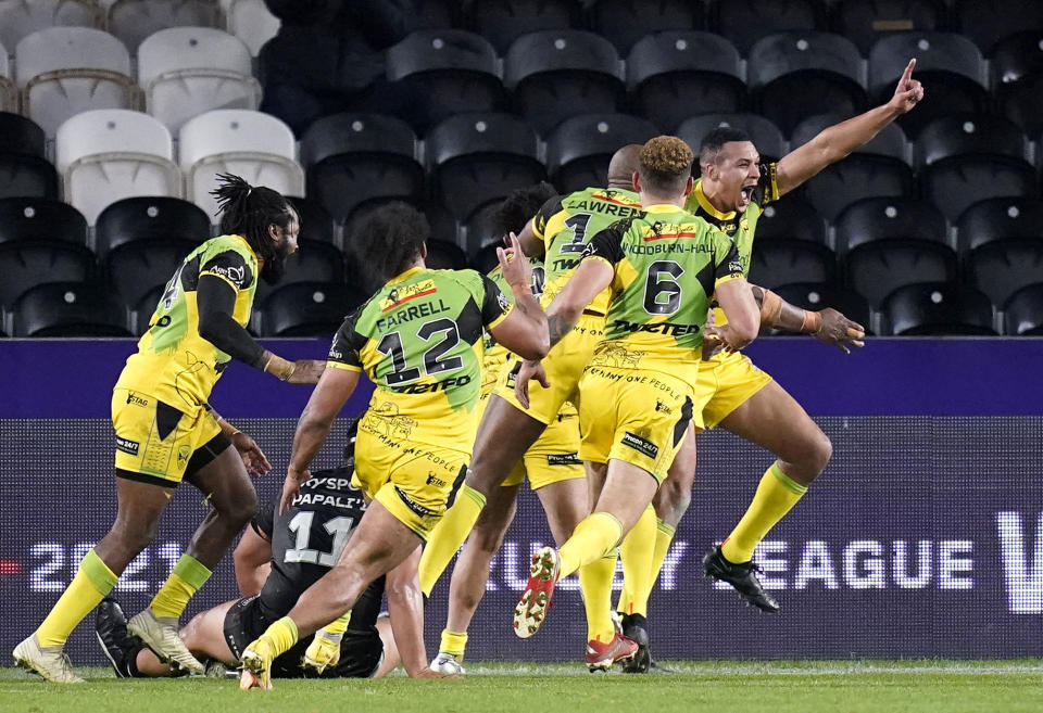 Jamaica's Ben Jones-Bishop, right, celebrates with teammates after scoring their side's first try during the Rugby League World Cup group C match between New Zealand and Jamaica at the MKM Stadium, Kingston upon Hull, England, Saturday Oct. 22, 2022. (Danny Lawson/PA via AP)