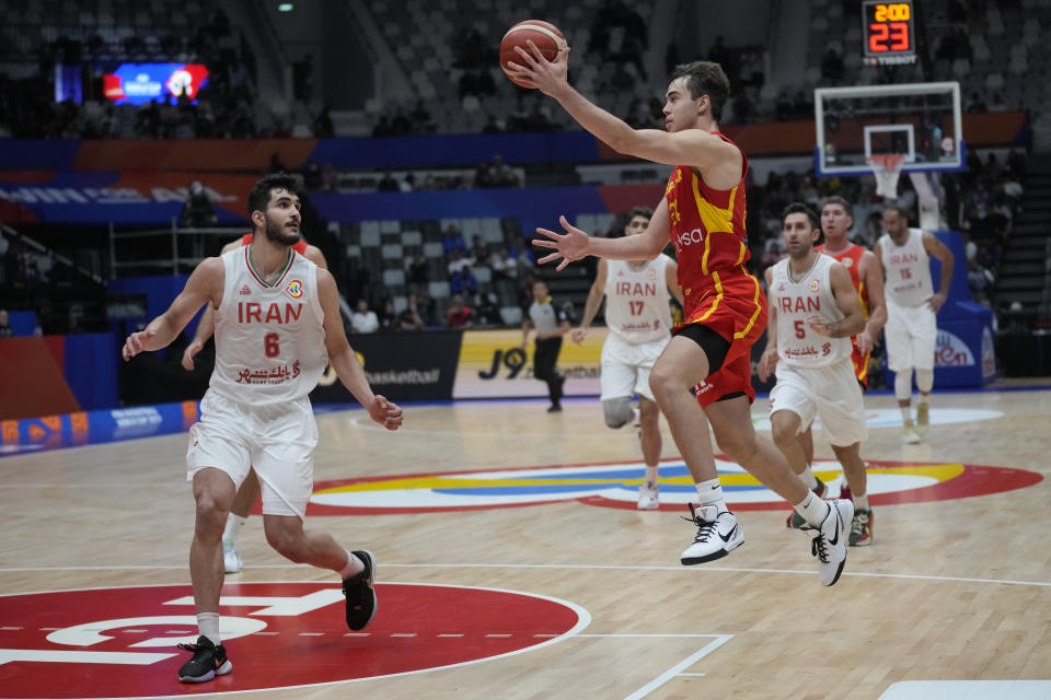 Spain guard Juan Nunez (24) drives past Iran forward Mohammad Amini (6) during the Basketball World Cup group G match between Spain and Iran at the Indonesia Arena stadium in Jakarta, Indonesia, Wednesday, Aug. 30, 2023. (AP Photo/Dita Alangkara)