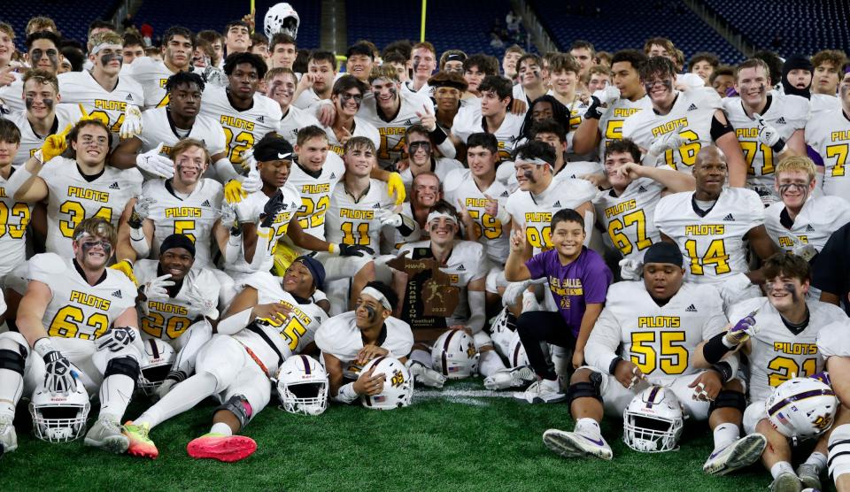 Warren De La Salle celebrates and gets its team picture taken after the Division 2 high school football finals between Warren De La Salle and Grand Rapids Forest Hills Central at Ford Field in Detroit on Friday, Nov 25, 2022.