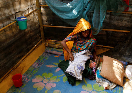 Fatema, 25, sits beside her one-day-old daughter Aasma in Kutupalang unregistered refugee camp in Cox’s Bazar, Bangladesh, February 9, 2017. REUTERS/Mohammad Ponir Hossain