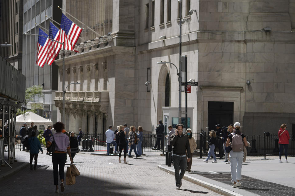 FILE - Visitors to the financial district walk past the New York Stock Exchange, Friday, Sept. 23, 2022, in New York. (AP Photo/Mary Altaffer, File)