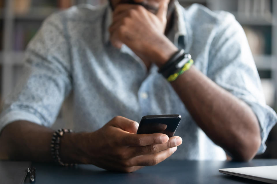 man holds cell phone close up view hands