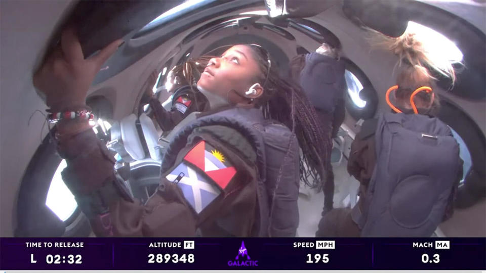 Anastatia Mayers, 18, takes in the view from nearly 55 miles up as she, her mother Keisha Schahaff, 46, Jon Goodwin, 80, and three Virgin Galactic crew members enjoy three to four minutes of weightlessness in the company's seventh sub-orbital spaceflight, the first with commercial space tourists aboard.  / Credit: Virgin Galactic