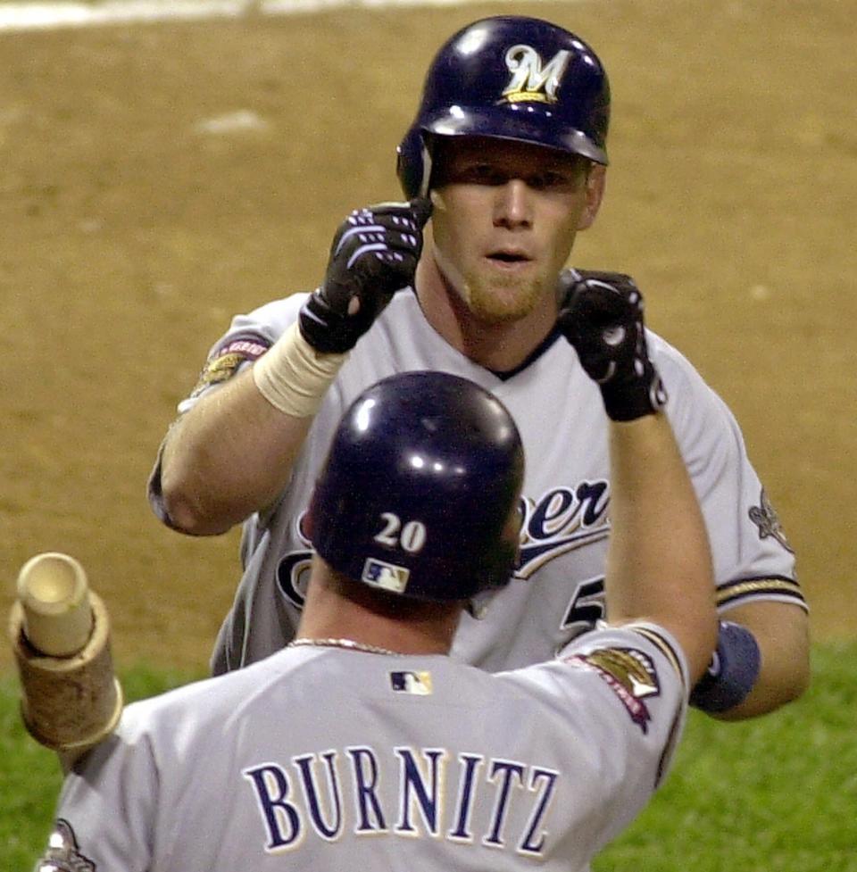Milwaukee Brewers' Geoff Jenkins (5) is greeted by teammate Jeromy Burnitz after Jenkins hit a home run in 2001.