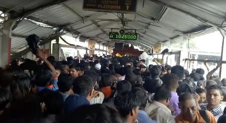 Crowds of commuters are seen moving along the Elphinstone railway station bridge around the time of a stampede, in Mumbai, India September 29, 2017, in this still image taken from social media video. TUSHAR SADAKE/via REUTERS