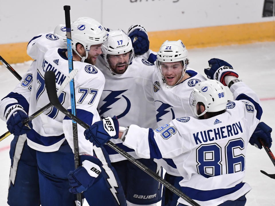 Tampa Bay Lightning's Victor Hedman (77). Alex Killorn (17) and Nikita Kucherov (86) celebrate after an NHL hockey game against the Buffalo Sabres in Globen Arena, Stockholm Sweden. Friday. Nov. 8, 2019. (Anders Wiklund/TT via AP)