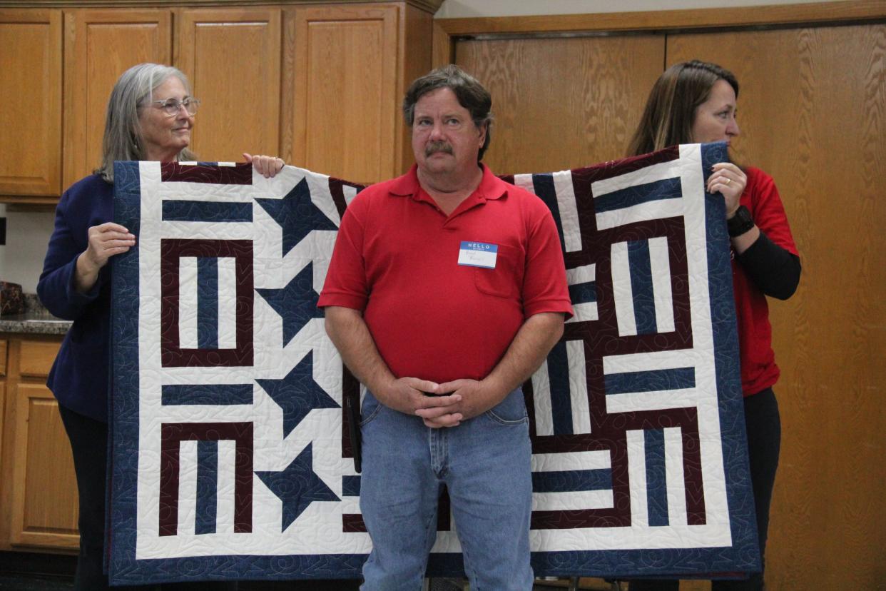 Brad Burrell receives a Quilt of Valor from the Perry Piecemakers Quilt Guild during a presentation on Friday, Nov. 10, 2023, at the Perry Elks Lodge.