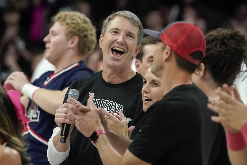 New Arizona head coach Brent Brennan, center, reacts to his introduction to the Arizona fans during a timeout of their NCAA college basketball game against Southern California Wednesday, Jan. 17, 2024, in Tucson, Ariz. (AP Photo/Darryl Webb)
