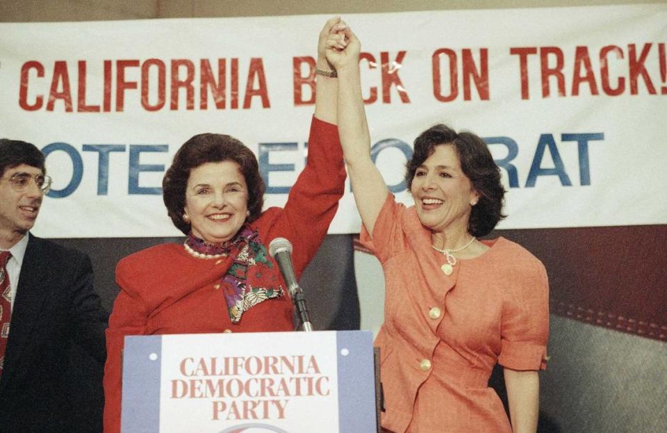 Dianne Feinstein, left, and Barbara Boxer raise their hands in victory during an appearance at the airport in Burbank on June 3, 1992. The two women won election to the U.S. Senate several months later. Feinstein, who served in the Senate for 30 years, died Friday, Sept. 29, 2023, at the age of 90.