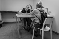 <p>Cynthia Abney listens to a recovering heroin addict at Groups in Middletown, Ohio.<br> (Photograph by Mary F. Calvert for Yahoo News) </p>