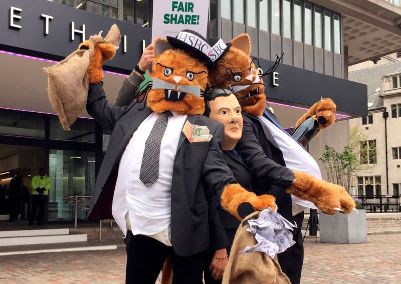 FILE PHOTO: Protestors wearing costumes pose outside the venue for the HSBC AGM in London