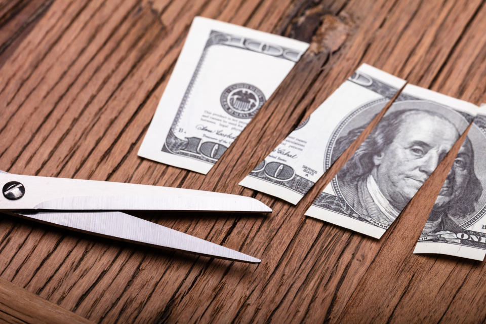 Cut up $100 bill and scissors