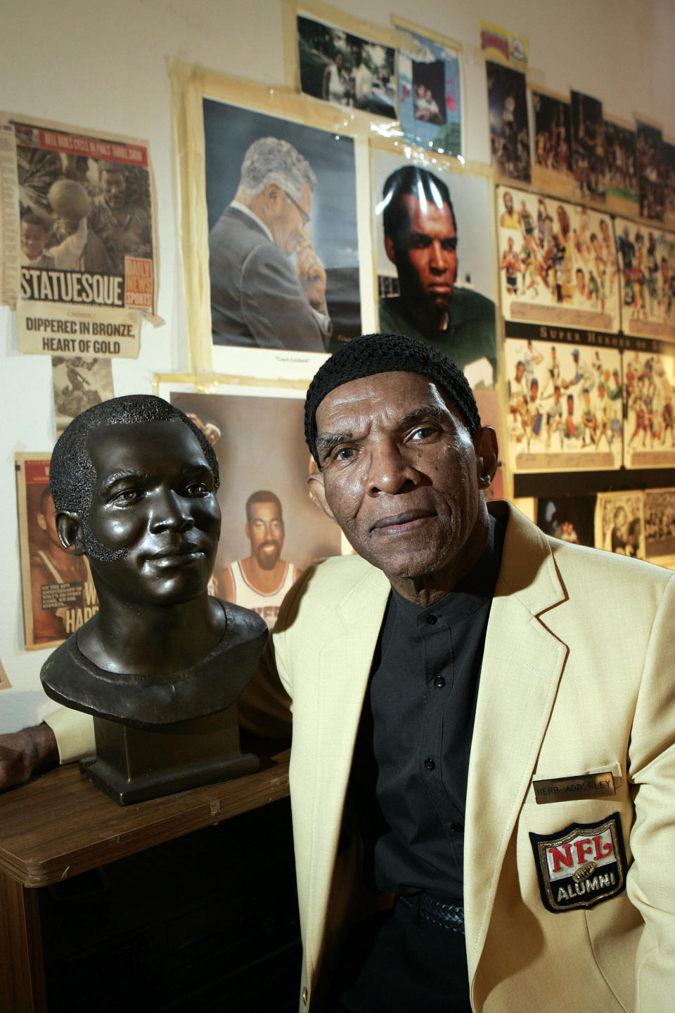 FILE - In this Oct. 2, 2008, file photo, former NFL player Herb Adderley poses next to a copy of his Hall of Fame bust in a room full of memorabilia from his playing days at his home in Mantua, N.J. Hall of Fame cornerback Herb Adderley has died. He was 81. His death was confirmed Friday, Oct. 30, 2020, on Twitter by nephew Nasir Adderley, a safety for the Los Angeles Chargers. Adderley played on six NFL title teams over a 12-year career with Green Bay and Dallas. (AP Photo/Mel Evans, File)