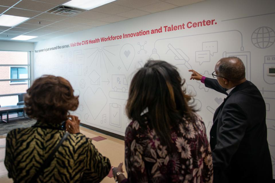 Senior Advisor of Workforce Initiatives for CVS Health Olivia Lang and Bishop Henry Williamson look at the new wall graphics during the Grand Opening of the Lane College and CVS Health WITC in Jackson, Tenn. on Tuesday, Apr. 11, 2023.