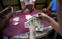 Gamblers play a Spanish card game known locally as "sakla" in an underground casino in Malabon, Metro Manila, Philippines, March 21, 2015. When paying your final respects for a relative or friend, the last thing you might expect to see at the wake is people placing bets on a card game or bingo. Not in the Philippines. Filipinos, like many Asians, love their gambling. But making wagers on games such as "sakla", the local version of Spanish tarot cards, is particularly common at wakes because the family of the deceased gets a share of the winnings to help cover funeral expenses. Authorities have sought to regulate betting but illegal games persist, with men and women, rich and poor, betting on anything from cockfighting to the Basque hard-rubber ball game of jai-alai, basketball to spider races. Many told Reuters photographer Erik De Castro that gambling is only an entertaining diversion in a country where two-fifths of the population live on $2 a day. But he found that some gamble every day. Casino security personnel told of customers begging to be banned from the premises, while a financier who lends gamblers money at high interest described the dozens of vehicles and wads of land titles given as collateral by those hoping lady luck would bring them riches. REUTERS/Erik De Castro PICTURE 17 OF 29 FOR WIDER IMAGE STORY "HIGH STAKES IN MANILA". SEARCH "BINGO ERIK" FOR ALL IMAGES.