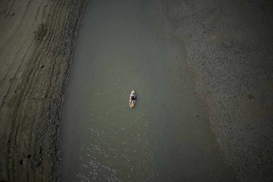 FILE - A paddle boarder passes through a drying portion of the Verdon Gorge in southern France, Tuesday, Aug. 9, 2022. France was in the midst of its fourth heat wave of the year Monday as the country faces what the government warned is its worst drought on record. (AP Photo/Daniel Cole, File)