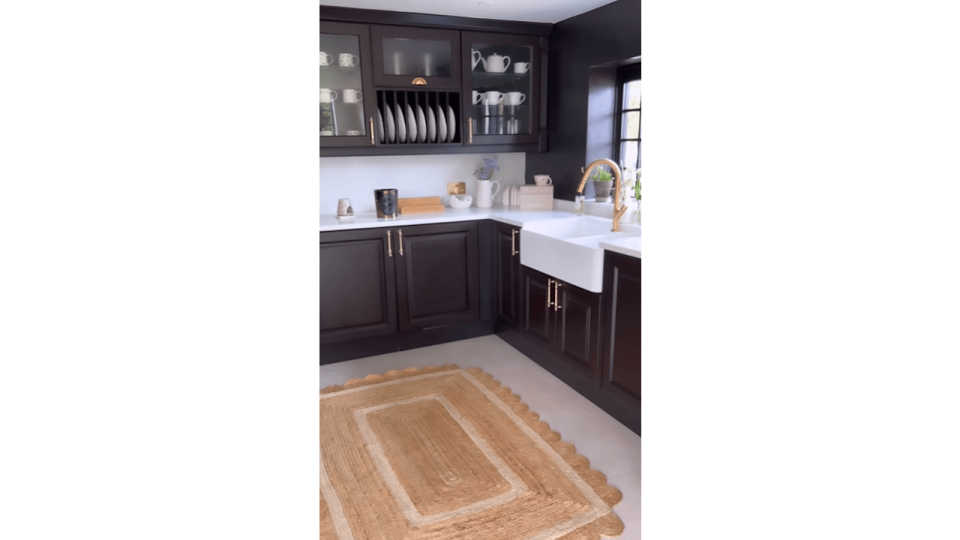 black kitchen with jute rug