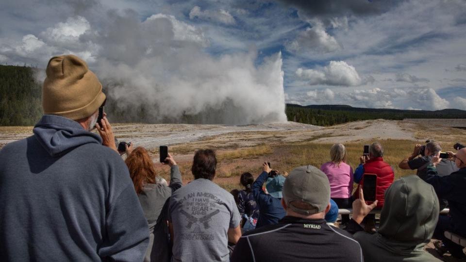 Close-up of tourists watching geyser