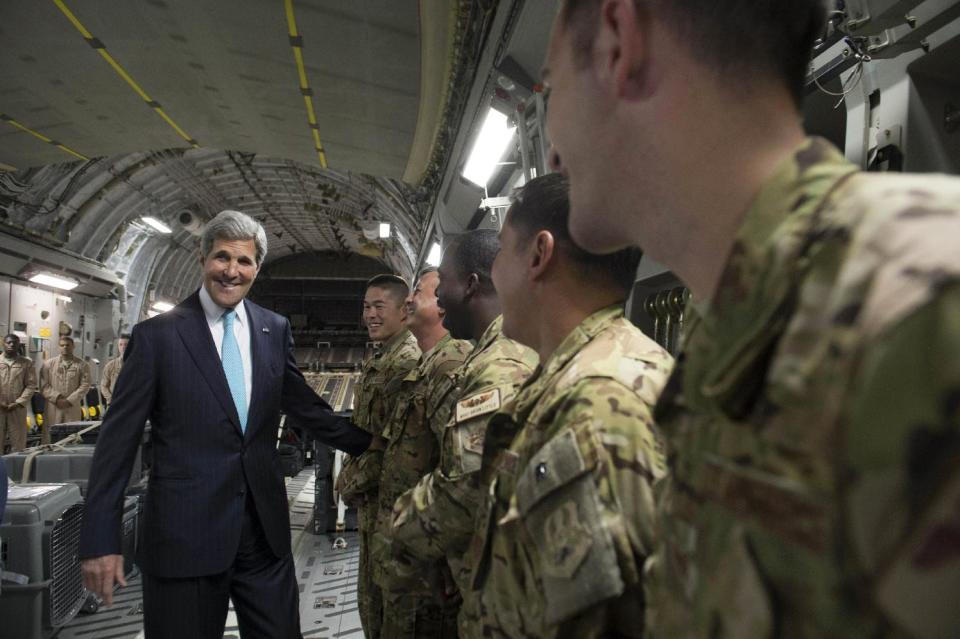 U.S. Secretary of State John Kerry, left, talks with the crew of a U.S. Air Force C-17 military airplane prior to departure from Addis Ababa, Ethiopia, enroute to Juba, South Sudan, Friday, May 2, 2014. Kerry is urging South Sudan's warring government and rebel leaders to uphold a monthslong promise to embrace a cease-fire or risk the specter of genocide through continued ethnic killings. (AP Photo/Saul Loeb, Pool)