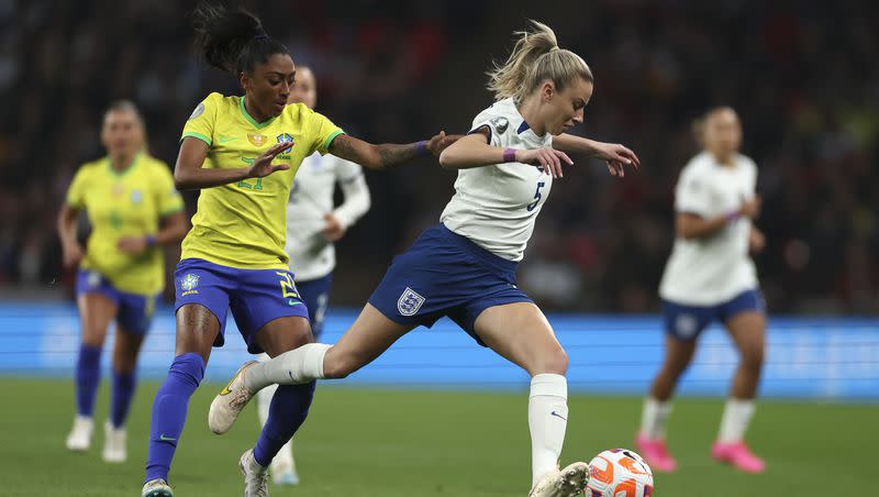 FILE — England’s Leah Williamson is challenged by Brazil’s Kerolin during the Women’s Finalissima soccer match between England and Brazil at Wembley stadium in London, Thursday, April 6, 2023. Williamson missed the Women’s World Cup because of a torn knee ligament, a growing issue in the sport of women’s soccer.