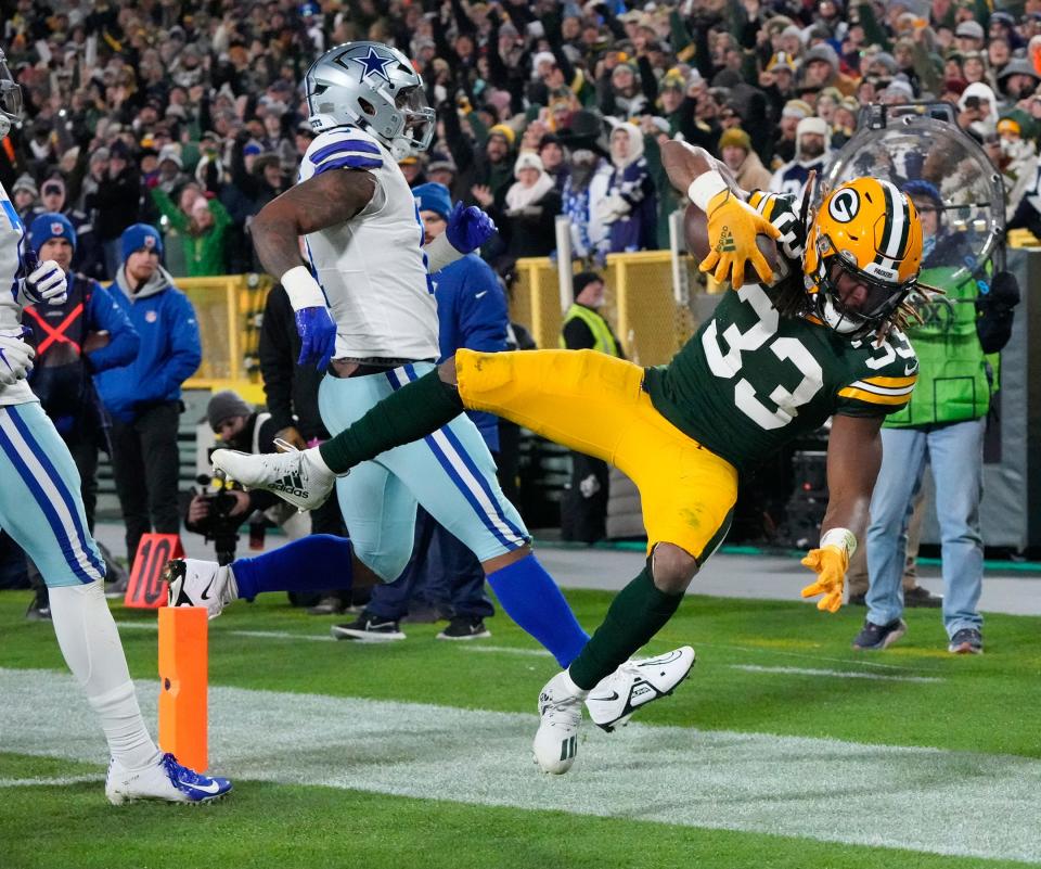 Green Bay Packers running back Aaron Jones scores a touchdown against the Dallas Cowboys during the first half of their game on Nov. 13, 2022, at Lambeau Field in Green Bay.
