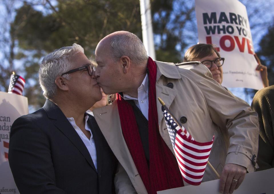 From left, Robert Roman and Claus Ihlemann of Virginia Beach celebrate with Carol Schall, Mary Townley , Tim Bostic and Tony London, Thursday's ruling by federal Judge Arenda Wright Allen that Virginia's same-sex marriage ban was unconstitutional during a news conference, Friday, Feb. 14, 2014 in Norfolk, Va. Wright Allen on Thursday issued a stay of her order while it is appealed, meaning that gay couples in Virginia still won’t be able to marry until the case is ultimately resolved. An appeal will be filed to the 4th District Court of Appeals, which could uphold the ban or side with Wright Allen. (AP Photo/The Virginian-Pilot, Bill Tiernan) MAGS OUT