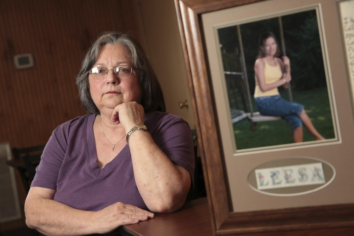 Wanda Farris sits beside a picture of her daughter, 16-year-old Leesa Gray, that hangs inside Comer's Restaurant in Dorsey Miss., Thursday Dec. 8, 2022. (Thomas Wells/The Northeast Mississippi Daily Journal via AP)