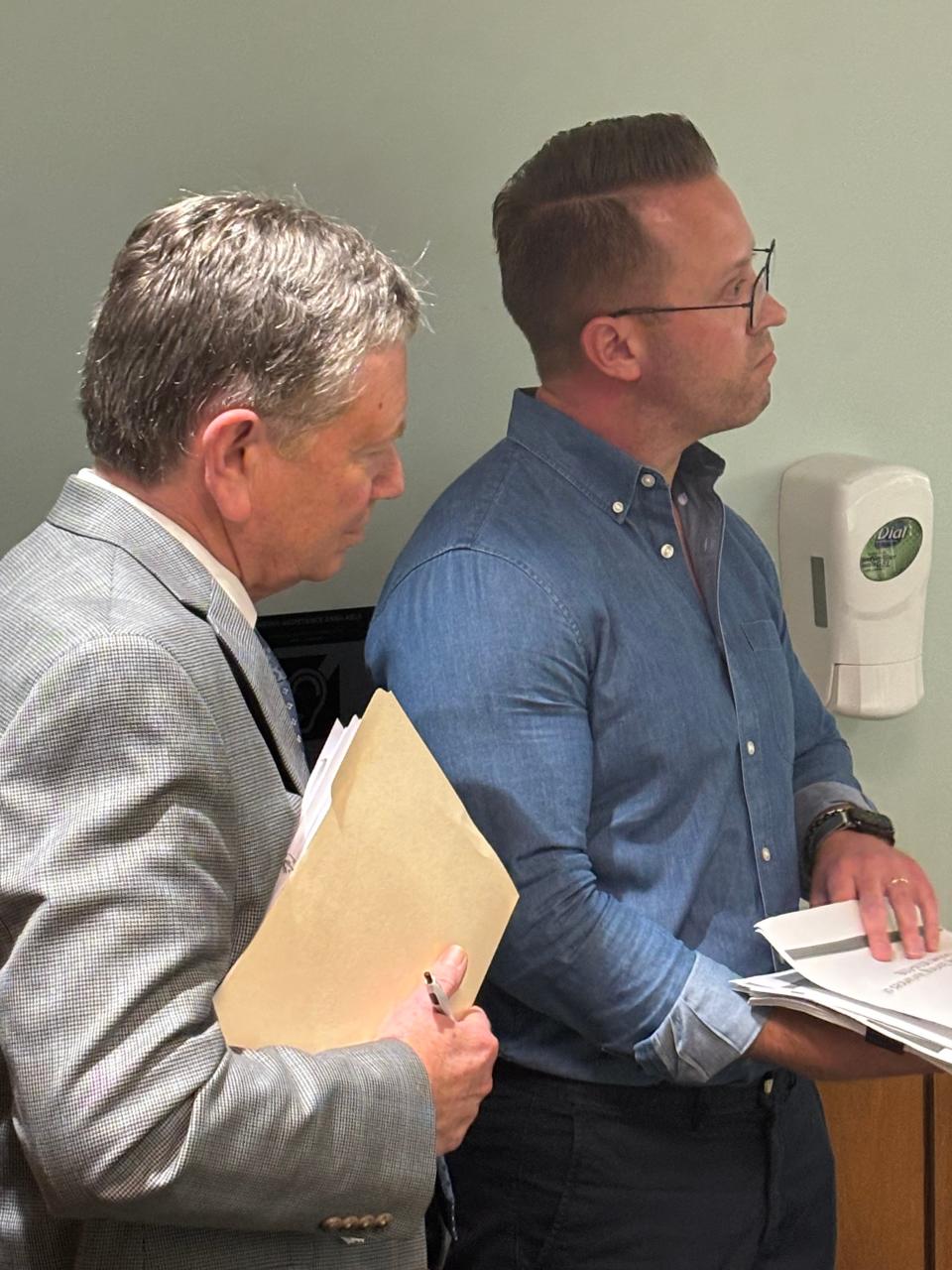 Matt McLaughlin, left, project manager for the Office of Public Works, and Taylor Bass, right, development manager for Becknell Industrial, listen to public comments during the zoning portion of the Springfield City Council meeting on July 16, 2024.