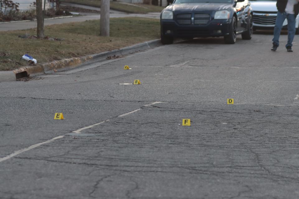 Evidence markers placed by Adrian police show the locations of bullet casings in the intersection of Frank and Tecumseh streets in Adrian after a shooting Feb. 13 between the occupants of two vehicles.