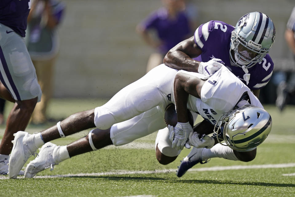 Nevada wide receiver Romeo Doubs (7) is tackled by Kansas State defensive back Russ Yeast (2) during the first half of an NCAA college football game Saturday, Sept. 18, 2021, in Manhattan, Kan. (AP Photo/Charlie Riedel)