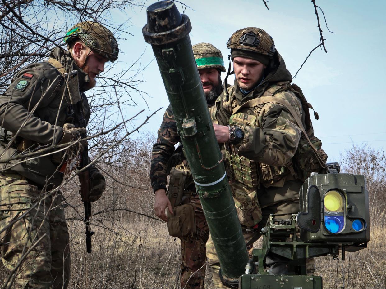 Ukrainian soldiers install an anti-tank missile systems 'Stugna' near Bakhmut (AP)