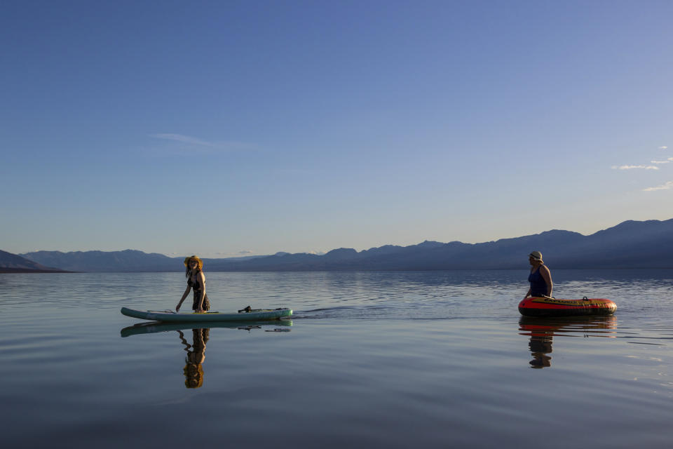 Alexandria Klein, left, and Laura Klein ride on a temporary lake in Death Valley on Thursday, Feb. 23, 2024, in Death Valley National Park, Calif. A series of storms have brought more than double the parks annual rainfall in the past six months. (AP Photo/Ty ONeil)