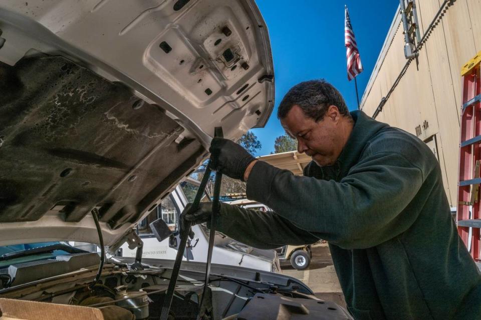 Sacramento State automotive service technician Matt Mason changes a fan belt on one of 300 vehicles he helps maintain last month. He has worked at the university for 20 years, and served as campus steward for Teamsters Local 2010 for much of that time.