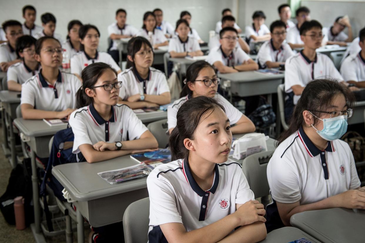 Students attend a class at Wuhan High School on the first day of the new semester in Wuhan in China's central Hubei province on Sept. 1, 2020.