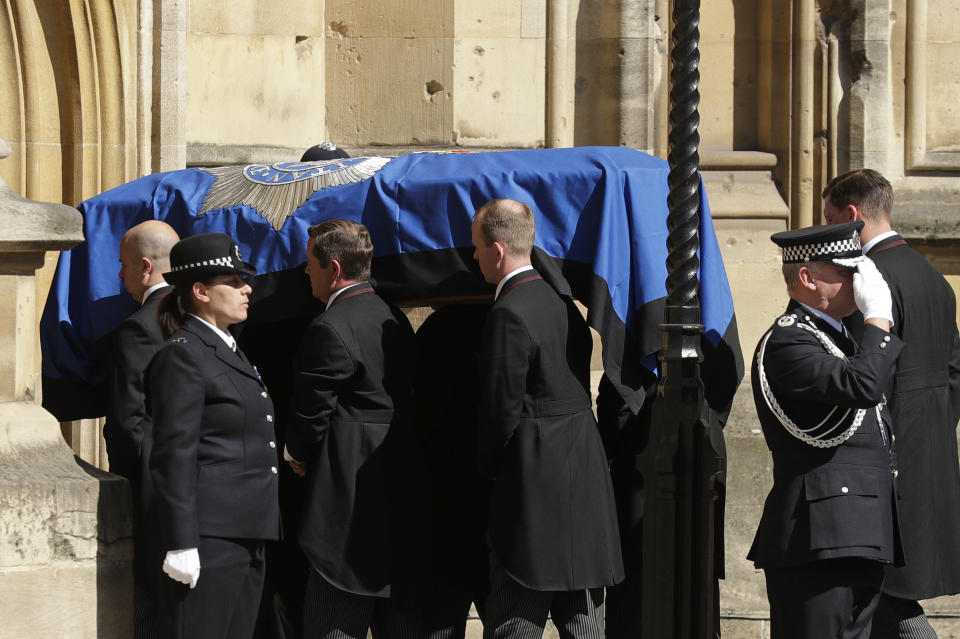 Pallbearers carrying the coffin of late police constable Keith Palmer, who was killed in the London attack on March 22, is carried into the Houses of Parliament to rest overnight in the Chapel of St Mary Undercroft, in London, Sunday, April 9, 2017. Palmer's funeral is due to take place at Southwark Cathedral in London on Monday. (AP Photo/Matt Dunham)