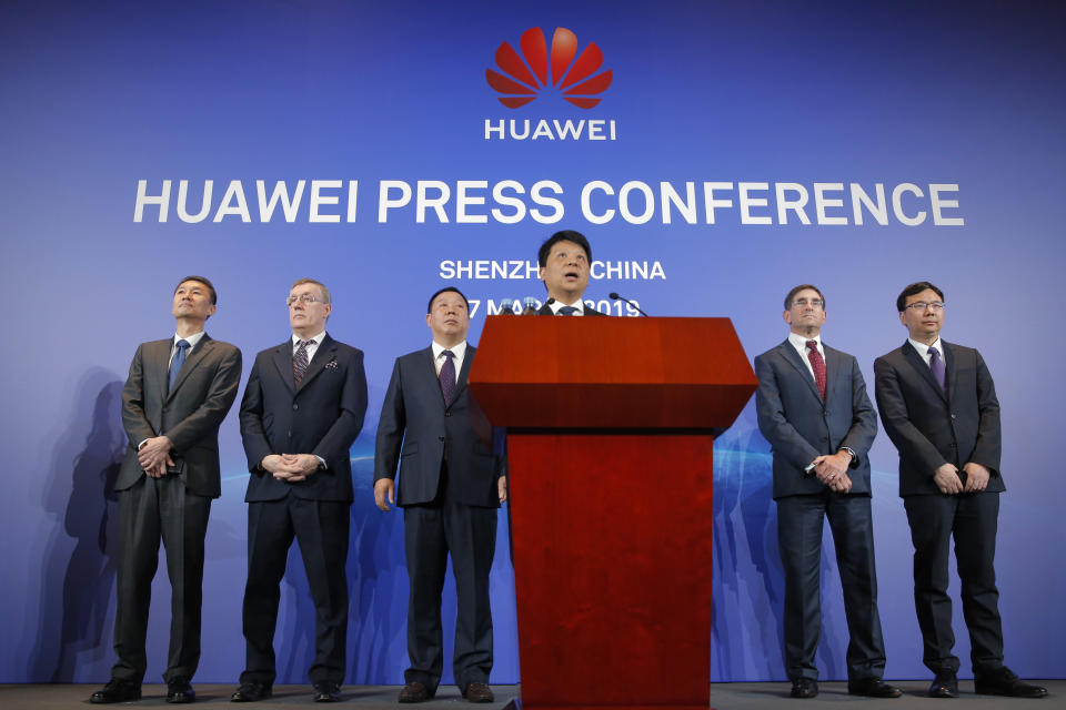 Huawei Rotating Chairman Guo Ping, center, speaks in front of other executives during a press conference in Shenzhen, China's Guangdong province, Thursday, March 7, 2019. Chinese tech giant Huawei is launching a U.S. court challenge to a law that labels the company a security risk and would limit its access to the American market for telecom equipment. (AP Photo/Kin Cheung)