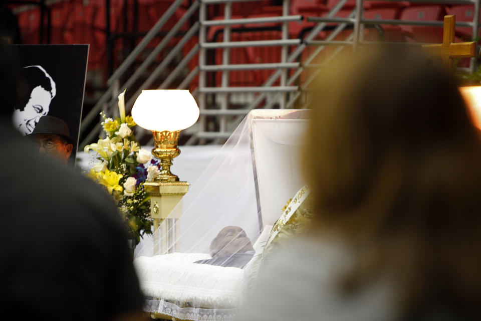 People mourn during the funeral of Cheo Feliciano, at the San Juan Coliseum in Puerto Rico, Saturday April 19, 2014. Feliciano, a member of the Fania All Stars died in a car crash early Thursday morning when he hit a light post before dawn in the northern suburb of Cupey in San Juan. He was 78. (AP Photo/Ricardo Arduengo)