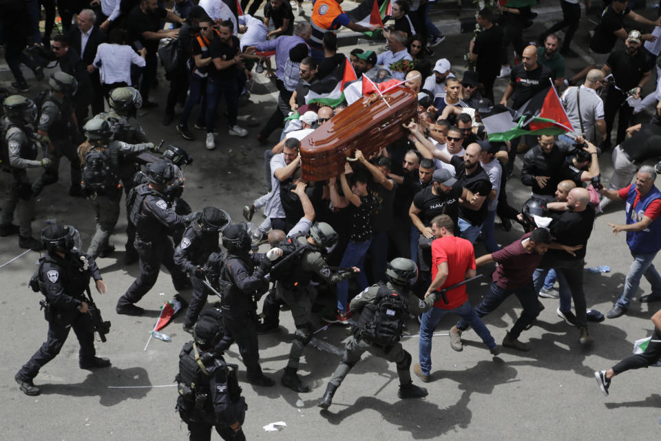 FILE - Israeli police clash with mourners as they carry the coffin of slain Al Jazeera journalist Shireen Abu Akleh during her funeral in east Jerusalem, on May 13, 2022. Abu Akleh, a Palestinian-American reporter who covered the Mideast conflict for more than 25 years, was shot dead two days earlier during an Israeli military raid in the West Bank town of Jenin. Photographer Maya Levin, for the Associated Pres, won the Asia Singles Category of the World Press Photo Contest, announced Thursday, April 20, 2023. (AP Photo/Maya Levin, File)