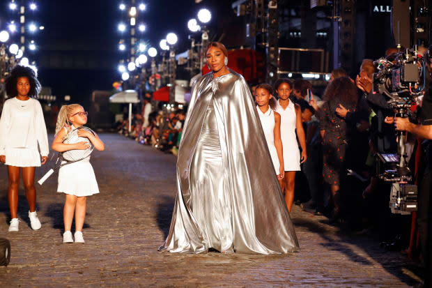 Serena Williams opens the show in a custom silver Balenciaga cape and gown, followed by four girls in white Nike outfits.<p>Photo: Getty Images for Vogue/Courtesy of Vogue</p>