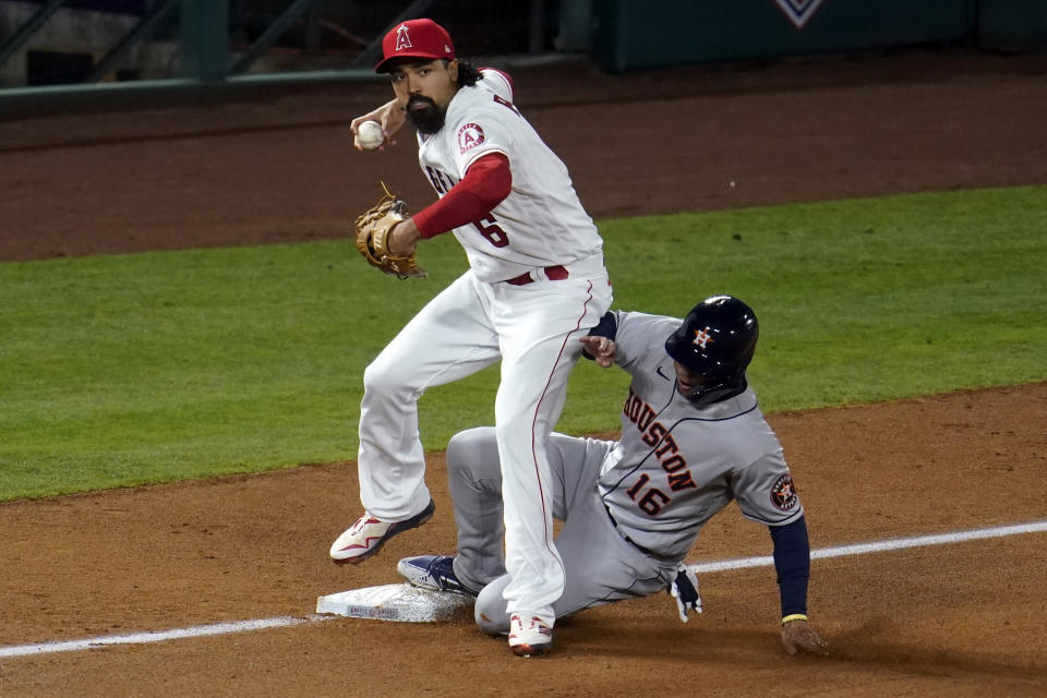 Houston Astros' Aledmys Diaz (16) is forced out at third base by Los Angeles Angels third baseman Anthony Rendon on a fielder's choice after a bunt by Martin Maldonado during the fourth inning of a baseball game Monday, April 5, 2021, in Anaheim, Calif. (AP Photo/Marcio Jose Sanchez)