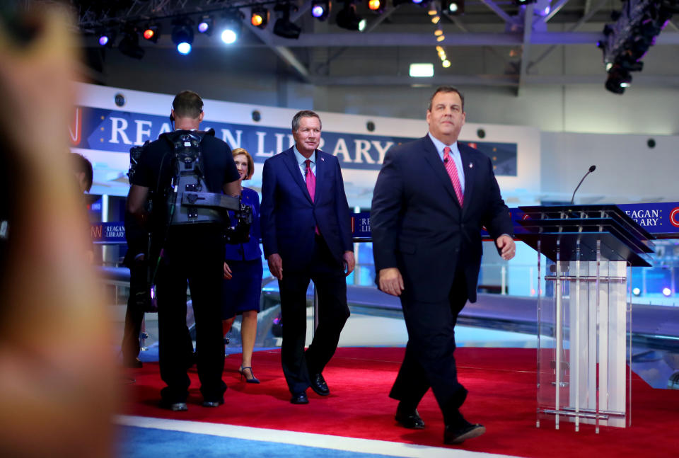 Republican presidential candidates (from left) Ohio Gov. John Kasich and New Jersey Gov. Chris Christie walk onstage with other candidates during the Republican presidential debates at the Reagan Library in Simi Valley on Sept. 16, 2015.