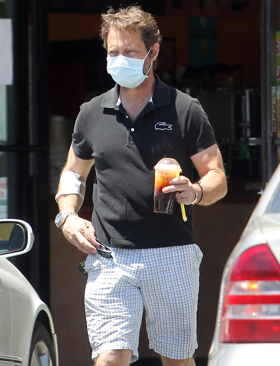 <p>Jason Priestley grabs a drink to-go as he runs errands on Thursday.</p>