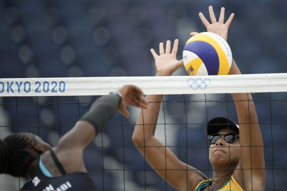 Ana Patricia Silva Ramos, right, of Brazil, blocks a shot by Brackcides Khadambi, of Kenya, during a women's beach volleyball match at the 2020 Summer Olympics, Monday, July 26, 2021, in Tokyo, Japan. (AP Photo/Felipe Dana)