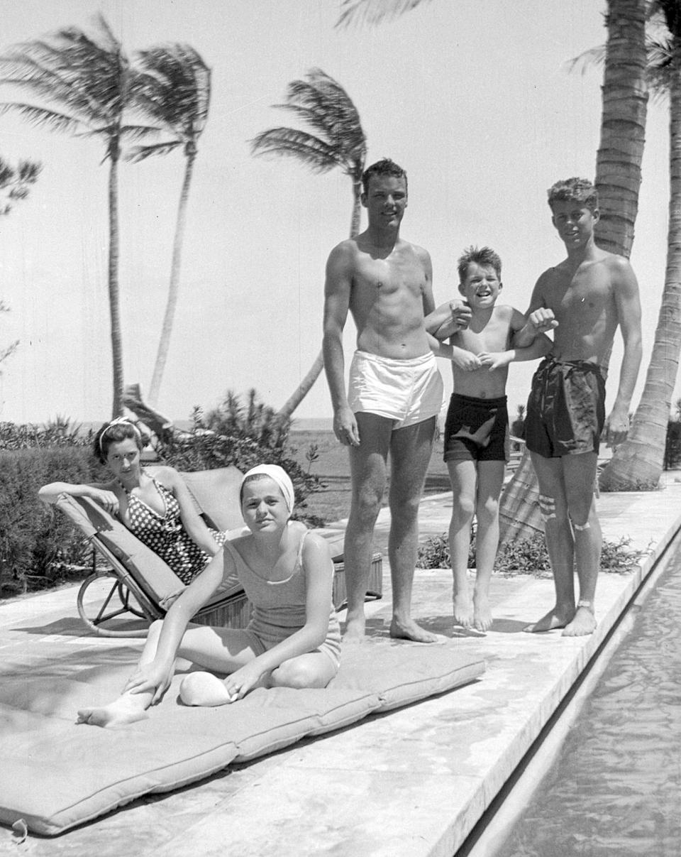 In this October 1936 photo provided by the Kennedy Family Collection, courtesy of the John F. Kennedy Library Foundation, John F. Kennedy, right, Robert F. Kennedy, second from right, and Patricia Kennedy, front left, pose with friends in Palm Beach, Fla. The Boston-based museum completed an 18-month project in 2018 to catalog and digitize more than 1,700 black-and-white Kennedy family snapshots that are viewable online, giving a nation still obsessed with "Camelot" a candid new glimpse into their everyday lives. (Kennedy Family Collection/John F. Kennedy Library Foundation via AP